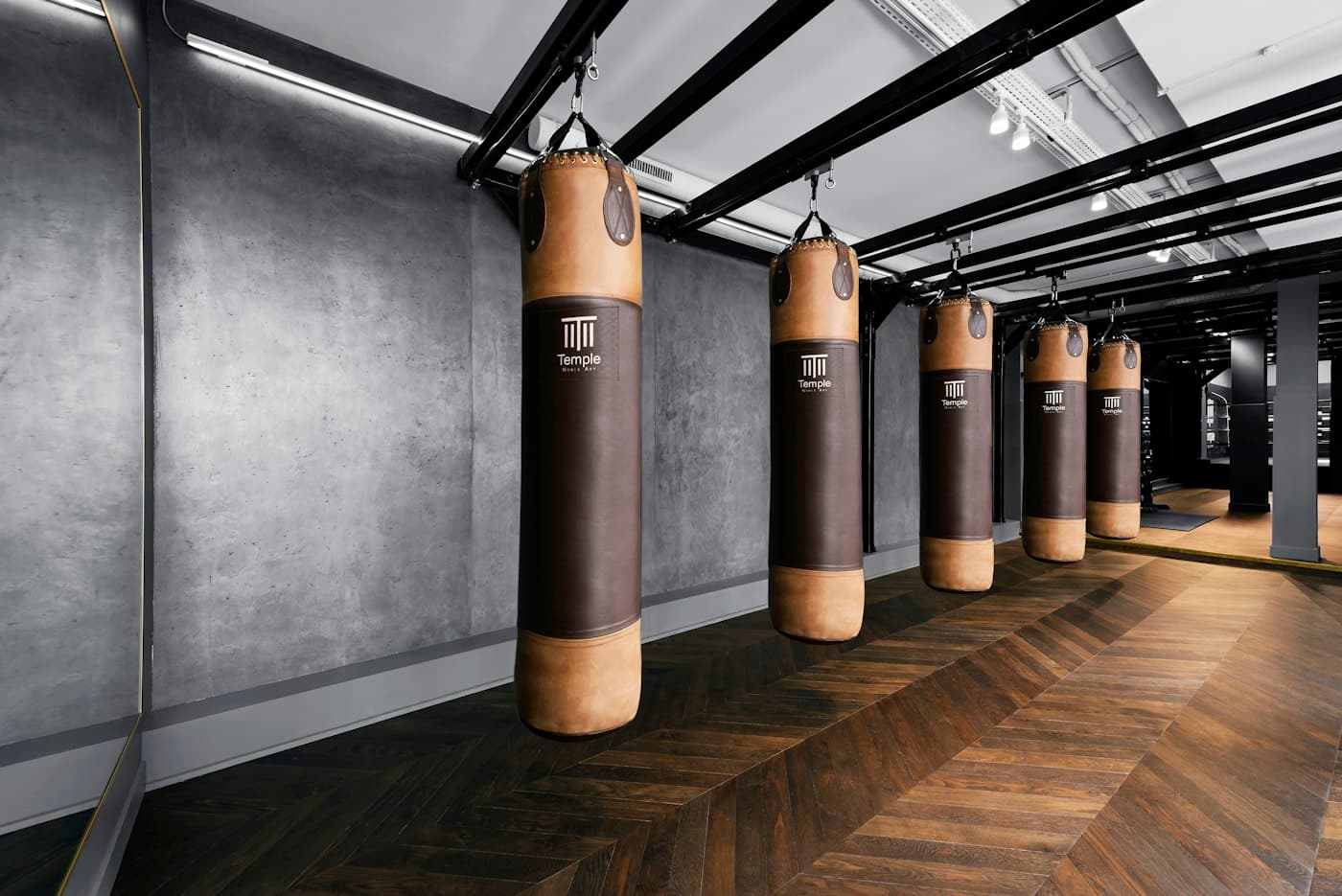 A row of heavy bags hanging in the studio