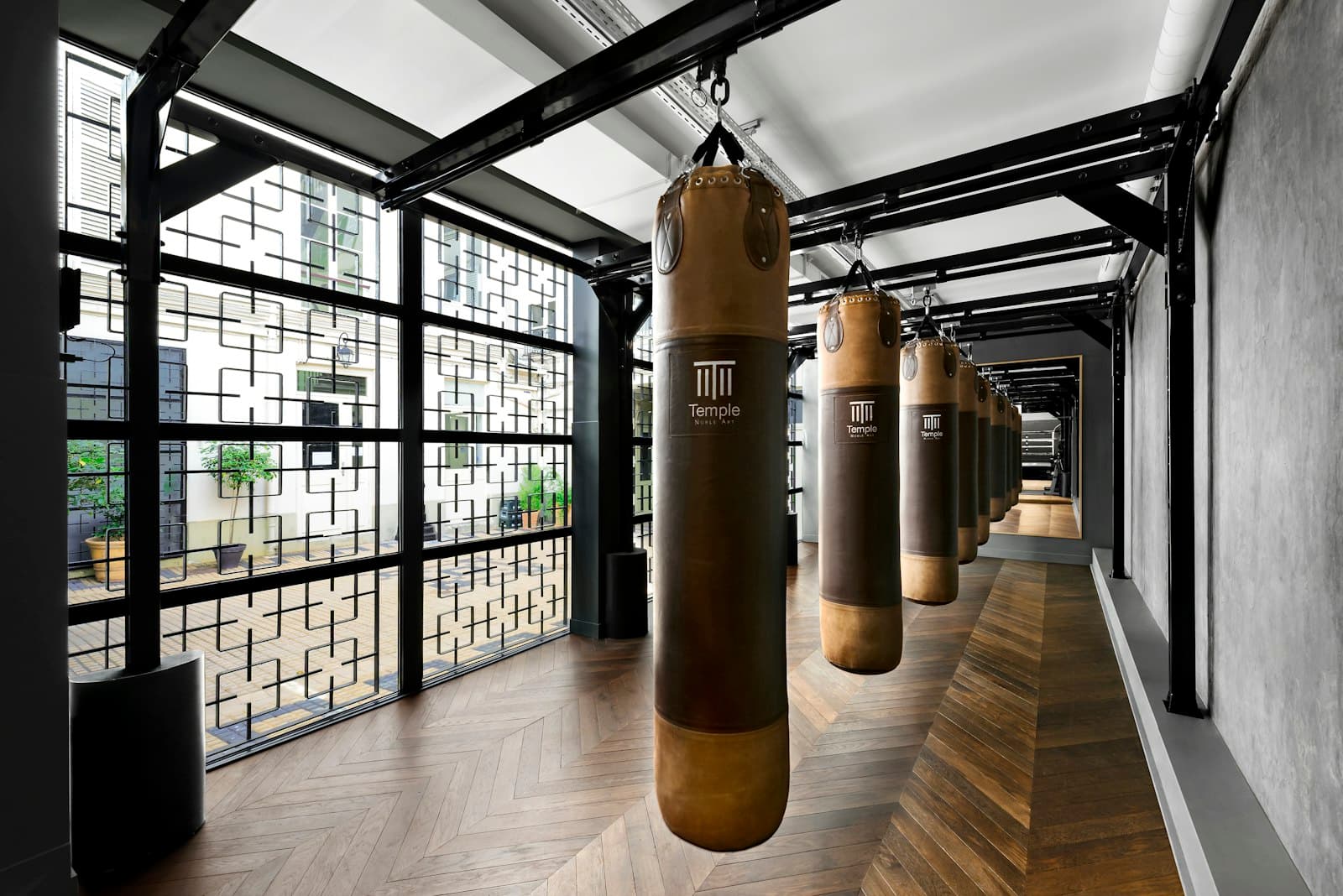 The Suavecito Boxing studio floor with heavy bags